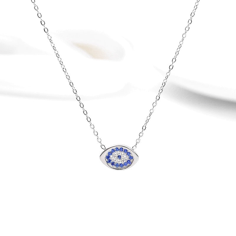 Celestial Evil Eye Zirconia Pendant with Halo Setting - front view on cream background
