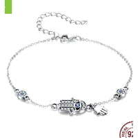 Hamsa Hand Bracelet with Evil Eye and Charms - front view on cream background